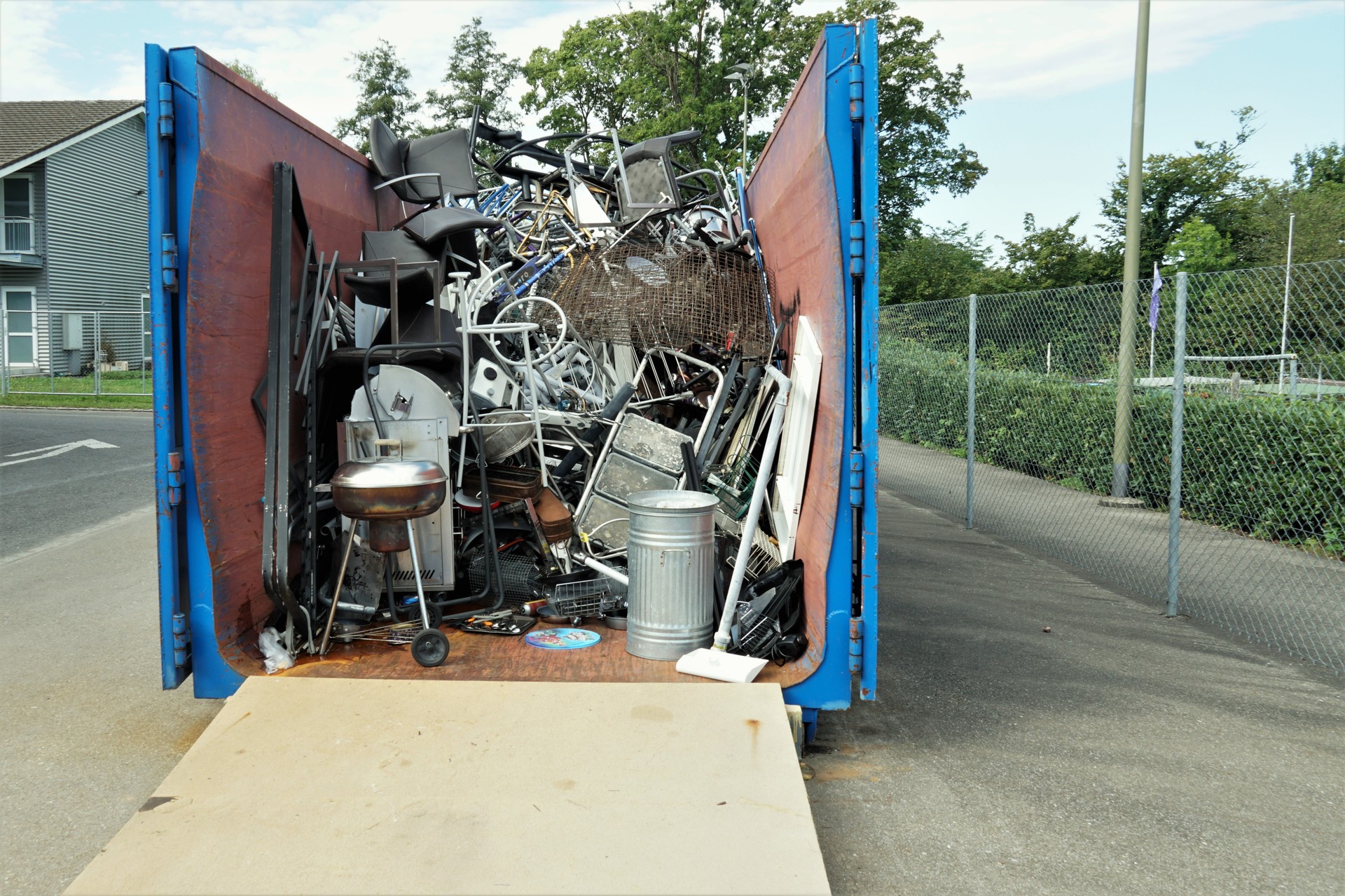 Metal waste collected in a container in a community disposal place.